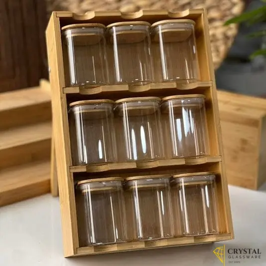 9-piece spice rack features clear glass jars with bamboo lids